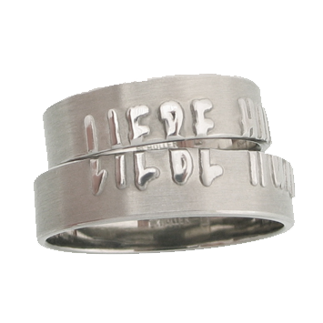 Editing:
Rolled, sawn, matted, polished, milled, engraved, hallmarked
Surface texture:
Matt, polished font, polished inside
Materials:
whitegold
Above all, special feature:
Split font, split symbols
Rings with engraved, raised writing distributed across the two partner rings.
Shape:
Band ring, square profile
Category:
Friendship ring, wedding ring, partner ring, poetry ring, writing ring, message ring
Style:
modern individual design
Ring width:
5.5mm
Material thickness:
1.2mm
Magical wedding rings or friendship rings made of platinum with raised writing. The words “Love humor tolerance” iare divided equally between the two partner rings.  Each partner receives half of the message, which can only be read when put together. The rings are each 5.5mm wide. The material thickness is 1.2mm. The rings have a matte surface, the raised lettering is polished, the inside is polished. The edges are pleasantly rounded and therefore feel great to wear. They are sustainably produced and 100% made in Germany.